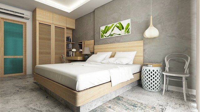 Nesta imagem, mostramos um quarto de casal moderno, tons de madeira e cinza, parede principal com cor de cimento queimado.